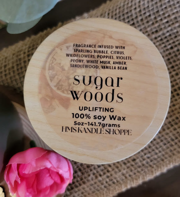 sugar woods-Uplifting Spiritual Kandle
5oz ~ 141.7 Champagne Gold Metal Tin, Faux woodgrain lid - 100% Soy Wax
This beautiful kandle is a classic white kandle with shimmering rosey succulents and a crackling wood wick.
This fragrance is infused with sparkling bubbles, citrus, wildflowers, poppies, violets, peony, white musk, amber, sandalwood and vanilla bean. This fragrance is a light and fun. It will elevate your mood.
Succulents represent enduring, timeless love, and adaptability, reminding us to ove