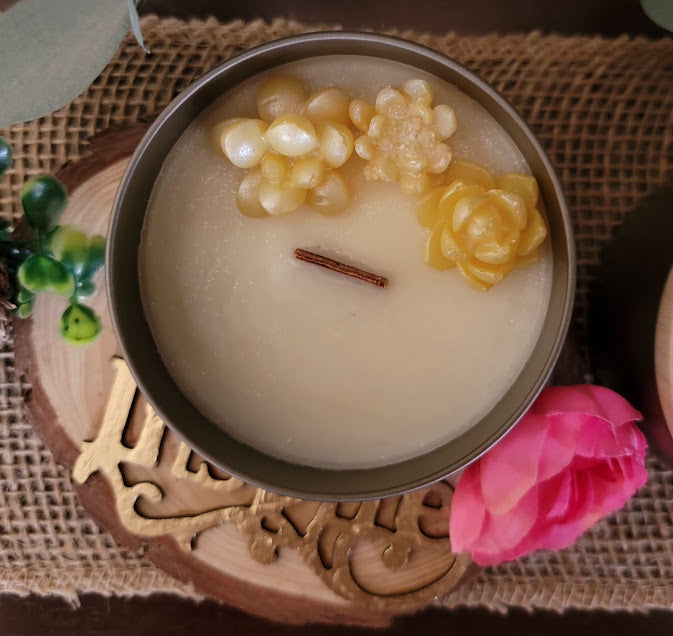 emon peel- Crisp &amp; Clean Spiritual Kandle

5oz ~ 141.7 Champagne Gold Metal Tin, Faux woodgrain lid - 100% Soy Wax

This beautiful kandle is a classic white kandle with shimmering yellow succulents and a crackling wood wick.

This fragrance is infused with tart juicy lemons, lemon citron, hints of lilac &amp; lemon rind. Notes to follow are ginger and wood. That lemony just cleaned fresh scent!

Succulents represent enduring, timeless love, and adaptability, reminding us to overcome adversity, maintain 