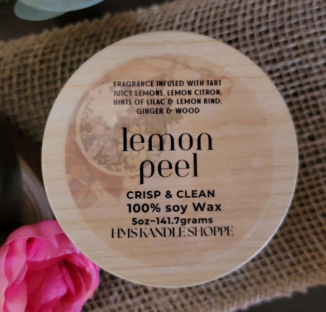 emon peel- Crisp &amp; Clean Spiritual Kandle

5oz ~ 141.7 Champagne Gold Metal Tin, Faux woodgrain lid - 100% Soy Wax

This beautiful kandle is a classic white kandle with shimmering yellow succulents and a crackling wood wick.

This fragrance is infused with tart juicy lemons, lemon citron, hints of lilac &amp; lemon rind. Notes to follow are ginger and wood. That lemony just cleaned fresh scent!

Succulents represent enduring, timeless love, and adaptability, reminding us to overcome adversity, maintain 