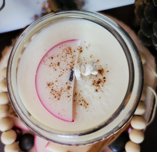 Rustik Apple Kandle-Spiritual

10oz Glass Jar with Ball Cork Lid

10oz~283grams 100% Soy Wax

Apple-Cinnamon&nbsp;

Infused with Dried Apple Slices&nbsp;&amp; Whole Cinnamon Sticks. This blend brings in self love, prosperity, protection. Assists in feeling safe, warm and cozy. Also a fun apple wax melt on top with a sprinkle of cinnamon.

The dried herbs are uniquely placed in the bottom of the jar set in a clear bubbly gel wax. The cotton wick is intentionally placed on top of the gel wax so that all of th
