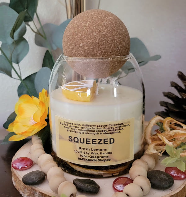Squeezed Kandle-Spiritual

10oz Glass Jar with Ball Cork Lid

10oz~283grams 100% Soy Wax

Fresh Lemons

Infused with Mulberry Leaves &amp; Dried Lemons. Brings in Sun Energy with clean, fresh high vibrational energy. Protection, grounding &amp; strength &amp; abundance. A fun lemon wedge on top of kandle.

The dried herbs are uniquely placed in the bottom of the jar set in a clear bubbly gel wax. The cotton wick is intentionally placed on top of the gel wax so that all of the natural elements are kept below