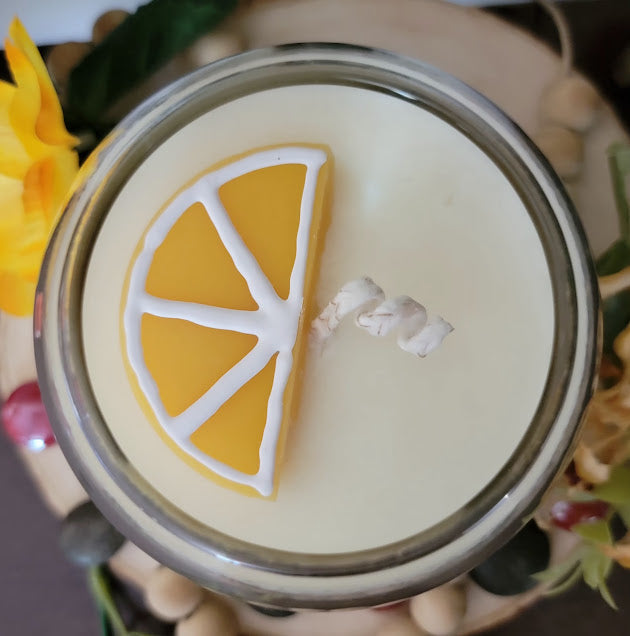 Squeezed Kandle-Spiritual

10oz Glass Jar with Ball Cork Lid

10oz~283grams 100% Soy Wax

Fresh Lemons

Infused with Mulberry Leaves &amp; Dried Lemons. Brings in Sun Energy with clean, fresh high vibrational energy. Protection, grounding &amp; strength &amp; abundance. A fun lemon wedge on top of kandle.

The dried herbs are uniquely placed in the bottom of the jar set in a clear bubbly gel wax. The cotton wick is intentionally placed on top of the gel wax so that all of the natural elements are kept below