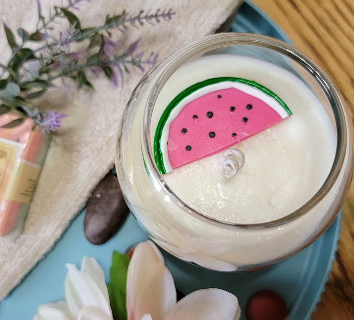 Watermelon-Lavender Kandle-Spiritual

10oz Glass Jar with Ball Cork Lid

10oz~283grams 100% Soy Wax

Fresh Watermelon with a hint of lavender.

Infused with Poppy Seeds &amp; Calendula. Combined with fragrance oil-assist bringing in abundance in all areas of our lives. relaxing &amp; Uplifting our moods and all-around good energy! Also, a fun wax melt watermelon on top.

The dried herbs are uniquely placed in the bottom of the jar set in a clear bubbly gel wax. The cotton wick is intentionally placed on top