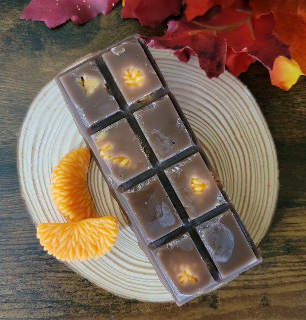 Midnight Orange Mocha Bar Wax Melts

3oz~85grams

100% Soy Wax Snap Bar

Fresh Orange &amp; Chocolate Fudge Fragrance&nbsp;

Infused with Chocolate and Orange fragrance oil. Gives a deep, luxurious, and warm evening vibe. Chocolate represents the Earth (Yin): It is dark, rich, deeply grounding, and introspective. Orange represents the Sun (Yang): It brings "light," vitality, radiant fire, and outward expression.

These bars make great gifts for chocolate lovers!&nbsp;

Use and Warnings..

Snap a square off 